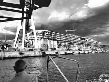 River in city against cloudy sky