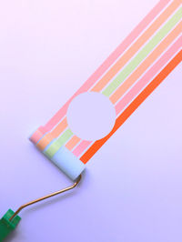 Close-up of colored pencils over white background