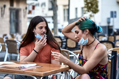 Women sitting on table at cafe