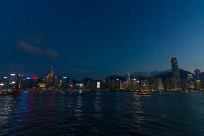 Illuminated city at waterfront