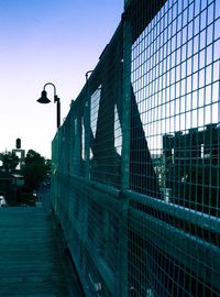 View of narrow footpath against clear blue sky