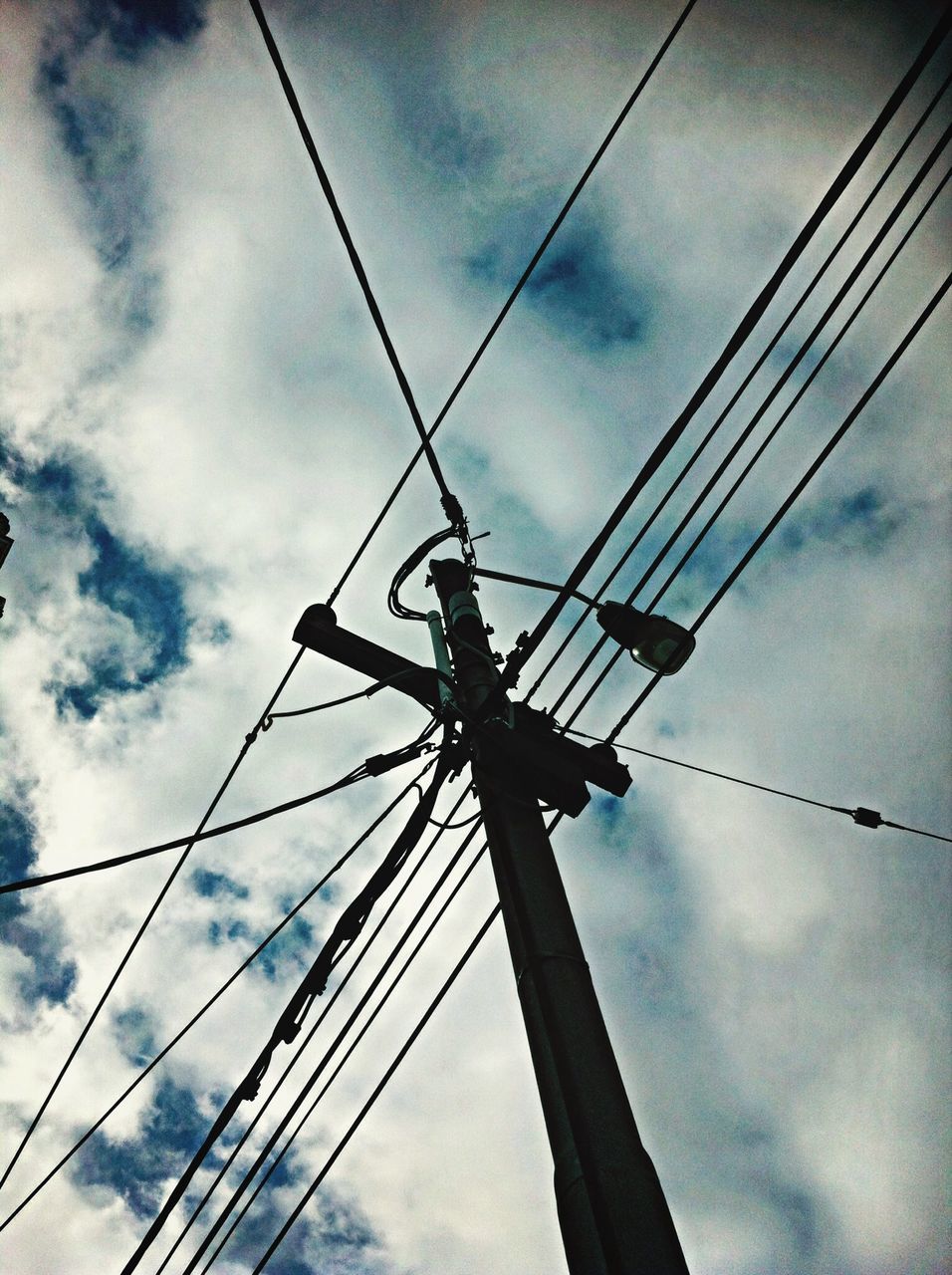 low angle view, power line, sky, power supply, connection, electricity, electricity pylon, cloud - sky, cable, fuel and power generation, cloudy, technology, cloud, complexity, built structure, no people, outdoors, day, silhouette, metal