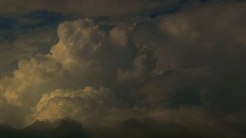 Low angle view of storm clouds in sky during sunset