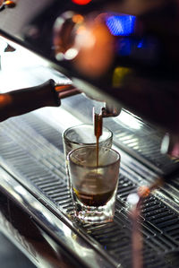 Close-up of coffee pouring in cup