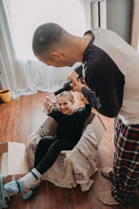 Friends sitting on floor at home