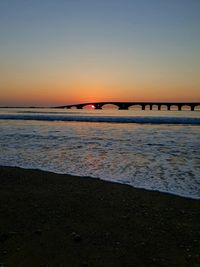 Scenic view of sea against clear sky during sunset