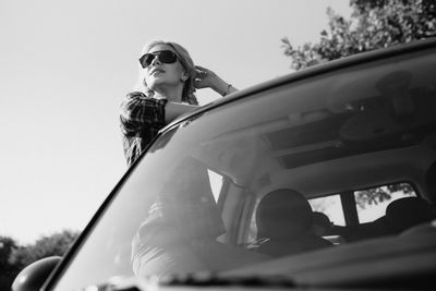 Portrait of woman with sunglasses against sky