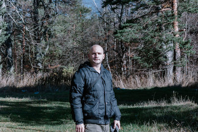 Portrait of bald man standing in park