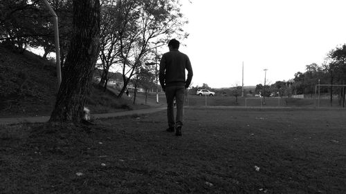 Rear view of man standing on field