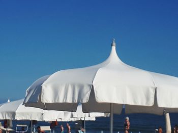 Panoramic view of beach against clear blue sky