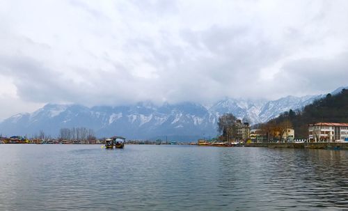 Scenic view of lake by mountains against sky