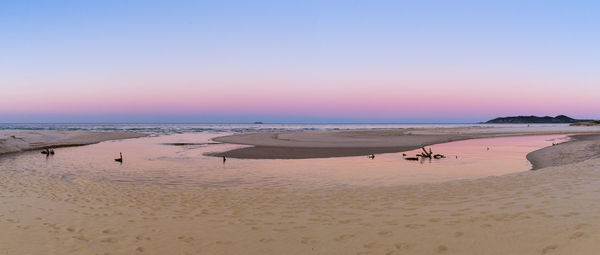 Scenic view of beach against clear sky