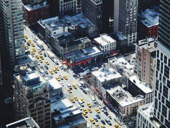 Traffic on city street amidst buildings