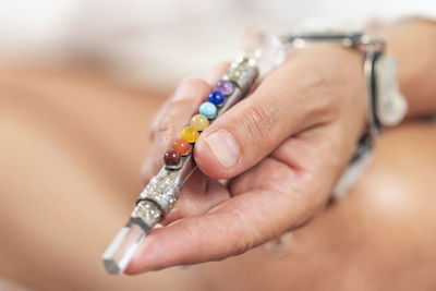 Midsection of woman holding crystal