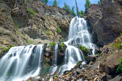 Low angle view of waterfall in forest