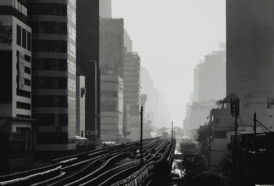Panoramic view of railroad tracks amidst buildings in city
