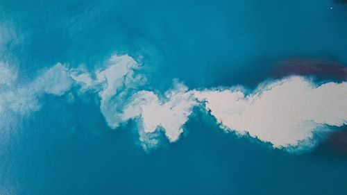 Low angle view of sea against blue sky