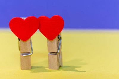 Close-up of heart shape on table against blue background