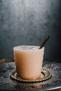 Creamy drink cocktail with tamarind soda, nutmeg, cinnamon, cacao nibs, chocolate on wooden barrel