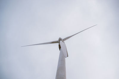 Low angle view of windmill against sky