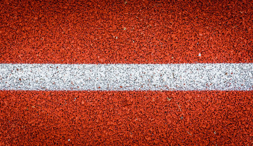 Full frame shot of sports track with white line
