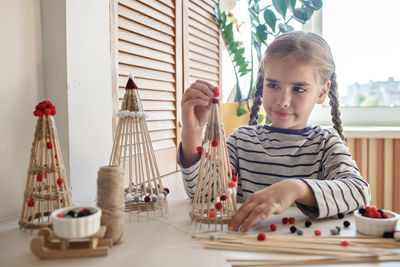 Cute girl playing with christmas ornaments