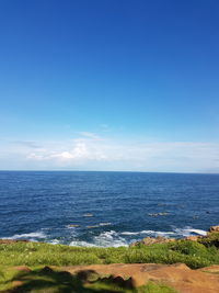 Scenic view of sea against clear blue sky