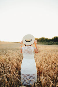 Full length of senior woman standing in farm