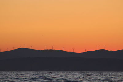 Scenic view of sea against orange sky