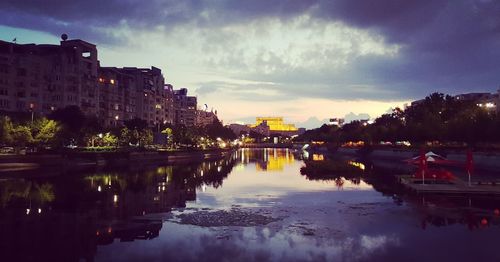 River amidst buildings in city against sky