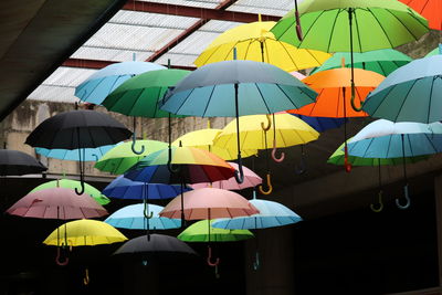 Low angle view of multi colored umbrellas hanging