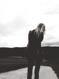 Silhouette of woman against sky