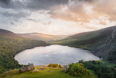 Scenic view of lake and mountains against sky