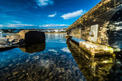 Reflection of buildings in lake against sky