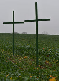 Wind turbines on field against sky