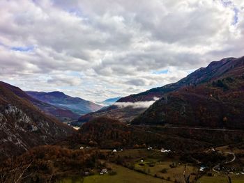 Top view of a village in a valley among the mountains and a haze of fog spreads between the hills