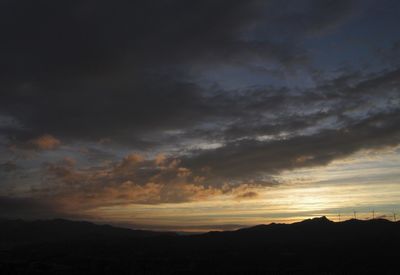 Scenic view of silhouette mountains against sky during sunset