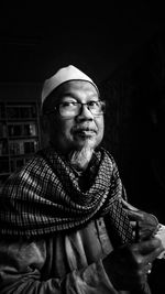 Portrait of man wearing skull cap in darkroom 