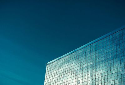 Low angle view of modern building against clear blue sky