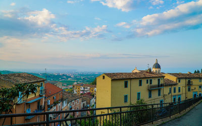 Buildings in town against sky