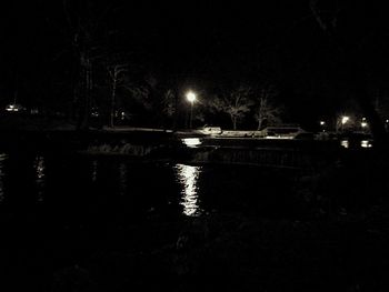 Reflection of illuminated lights in puddle