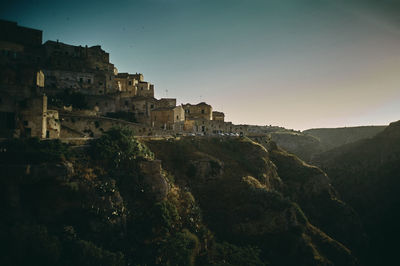 Scenic view of an old italian city with mountains against sky