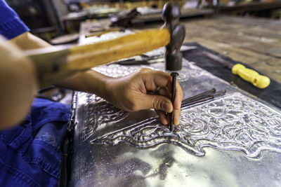Silverware making. thai craftman are making silverware. the original of the silver craftsmen.