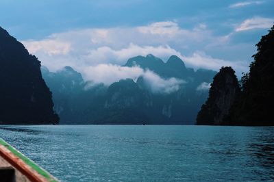 Scenic view of sea and mountains against sky