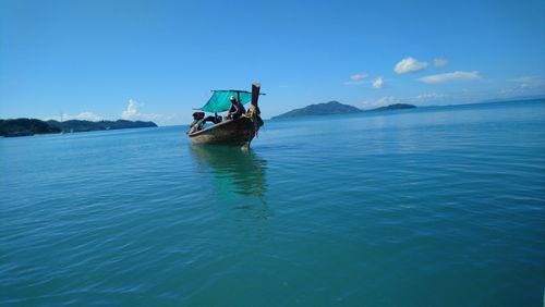 Boat in sea against blue sky