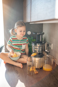 Portrait of cute boy sitting on table