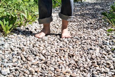 Low section of person standing on rock