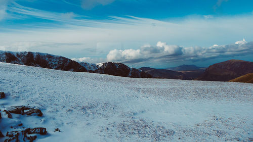 Scenic view of snow covered mountains against sky