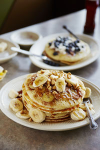 Pancakes served with banana slices in plate