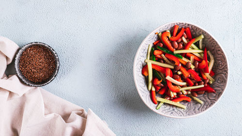 Vegetable salad of red beans, cucumber and fresh pepper in a bowl on the table top view web banner